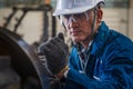 Industrail background of caucasian mechanics engineer operating lathe machine for metalwork in metal work factory