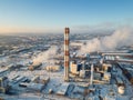 industrial aerial top view of heating power station and chimney or smoke stack at snowy weather, cold winter and snow Royalty Free Stock Photo