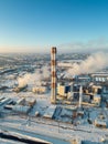 industrial aerial top view of heating power station and chimney or smoke stack at snowy weather, cold winter and snow Royalty Free Stock Photo