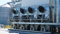 industrial air conditioner. Air conditioner units HVAC on a roof of industrial building with blue sky and clouds in the Royalty Free Stock Photo