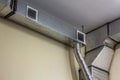 Industrial air duct ventilation equipment and pipe systems installed on industrial building ceiling.