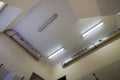 Industrial air duct ventilation equipment and pipe systems installed on building ceiling and walls. Comfortable workplace concept