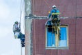 Industrial alpinism. Workers are restoring the building. Mountaineering, repairs, dangerous work at height