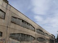 Industrial archeology buildings in the city of Busto Arsizio. Facade of an old factory with glass block windows Royalty Free Stock Photo