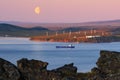 Industrial arctic landscape with a cargo ship and a wind farm Royalty Free Stock Photo