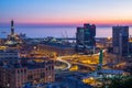 Industrial area near the port with Lanterna and commercial skyscrapers at sunset, Genoa, Italy.