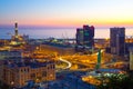 Industrial area near the port with Lanterna and commercial skyscrapers at sunset, Genoa, Italy.