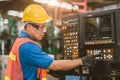 Industrial Asian worker operating lathe milling CNC machine at metal machining heavy industry Royalty Free Stock Photo