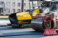 Industrial asphalt paver machine laying fresh asphalt and a Heavy road roller with vibration roller compactor press new Royalty Free Stock Photo