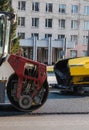 Industrial asphalt paver machine laying fresh asphalt and a Heavy road roller with vibration roller compactor press new Royalty Free Stock Photo