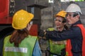 Industrial background of asian male mechanic engineer supervisor explaining machine work procedure to new female mechanic engineer