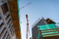 Industrial Background, bottom view of working crane on business building Royalty Free Stock Photo