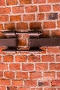 Industrial background brick row of red stones with metal plate with long screws parallel row