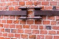 Industrial background fastening cracked wall rusty old fastening for pipes fastened red brick wall