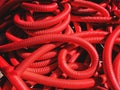 Industrial background. Plastic corrugated pipes, drainage in the roll, close-up. Red tubes or pipeline. Royalty Free Stock Photo