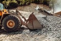 Industrial backhoe excavator and wheel loader working on construction site Royalty Free Stock Photo