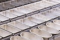 Industrial bakery automated line. Filling metal molds for baking bread