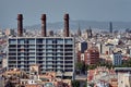 Industrial Barcelona. Three red brick chimney pipes with historic Barcelona on background