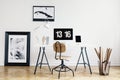 Industrial basket with kraft paper rolls and a framed poster in a white, minimalist home office interior of a freelancer architect Royalty Free Stock Photo