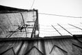 Industrial building with barbed wire from below, black and white