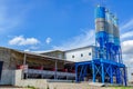 Industrial building with big blue tanks for cement, sand, water. Paving plant. Panoramic photo Royalty Free Stock Photo