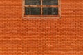 Industrial building brick wall with old metal window as background Royalty Free Stock Photo