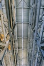 Industrial building ceiling with metal brace frame link. View from bottom to top