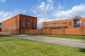 Industrial building with office building. Production room made of brick. Red brick fence. Small factory.