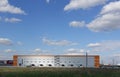 Industrial building, warehouse. Blue sky with clouds