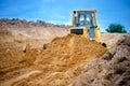 Industrial bulldozer and excavator working with earth in sandpit Royalty Free Stock Photo