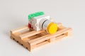 Industrial button for industrial control panels yellow equipment lies on a wooden pallet