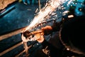 Industrial caucasian male worker, close up workers hands with power tool with circular blade grinder