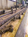 Industrial Chain Track with Greased Rollers and Aged Metal Components in Factory Royalty Free Stock Photo