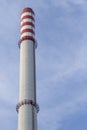 Industrial chimney on blue sky background