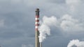 Industrial chimney expelling smoke columns in a industrial factory