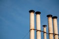 Industrial chimney heating pipes on blue sky background