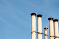 Industrial chimney heating pipes on blue sky background