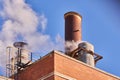 Industrial chimney releasing fumes, steam and polluting gases