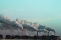 Industrial chimneys with heavy smoke causing air pollution Royalty Free Stock Photo