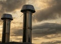 Industrial chrome pipes over sunset cloudy sky background Royalty Free Stock Photo