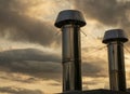 Industrial chrome pipes over sunset cloudy sky background Royalty Free Stock Photo