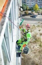 Industrial climber on building during winterization works, looking up at camera and smiling Royalty Free Stock Photo