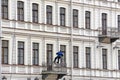 An industrial climber hanging on a rope