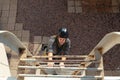 A white man in a black helmet climbs the stairs on a sunny day Royalty Free Stock Photo