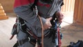 Industrial climber puts on equipment for high-altitude work. on the climber s belt carabiners.