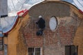 Industrial climber restores wall on the building. Royalty Free Stock Photo