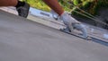 Industrial climber sanding wall with sandpaper for subsequent painting. Slow