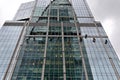 Industrial climber washes glass on the facade of a skyscraper Royalty Free Stock Photo