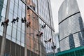 Industrial climber washes glass on the facade of a skyscraper Royalty Free Stock Photo