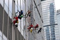 Industrial climber washes glass, high-rise facade cleaning services